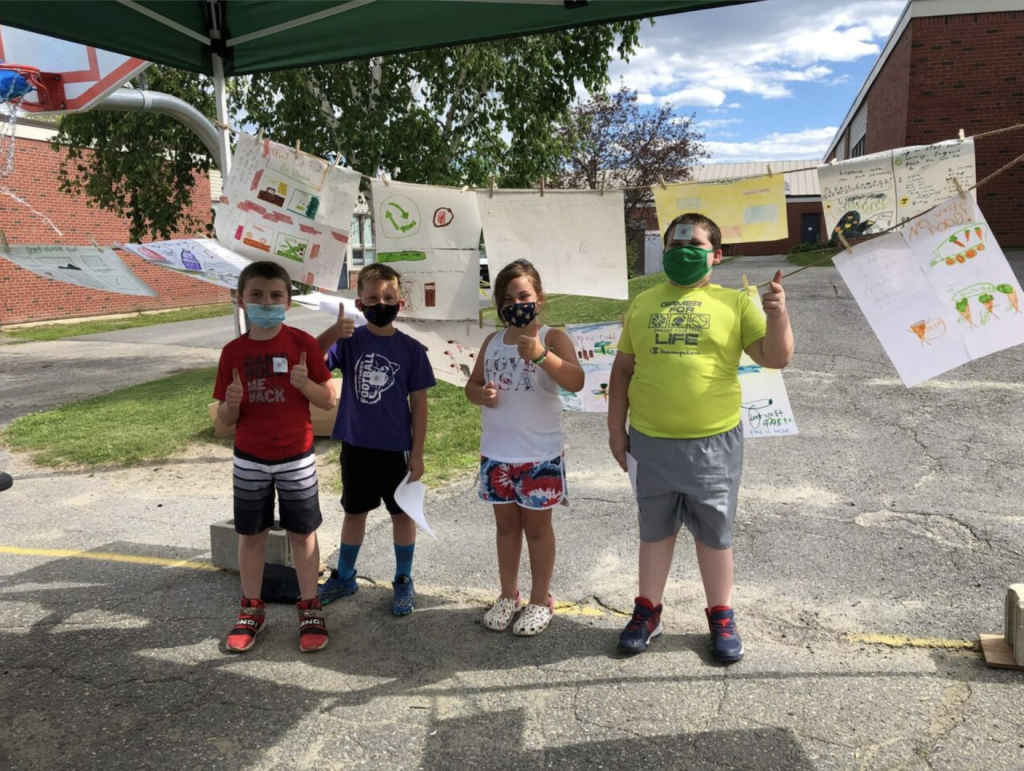 Four kids making thumbs up